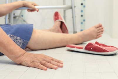 Leg of elderly woman on bathroom floor depicting a bone fracture